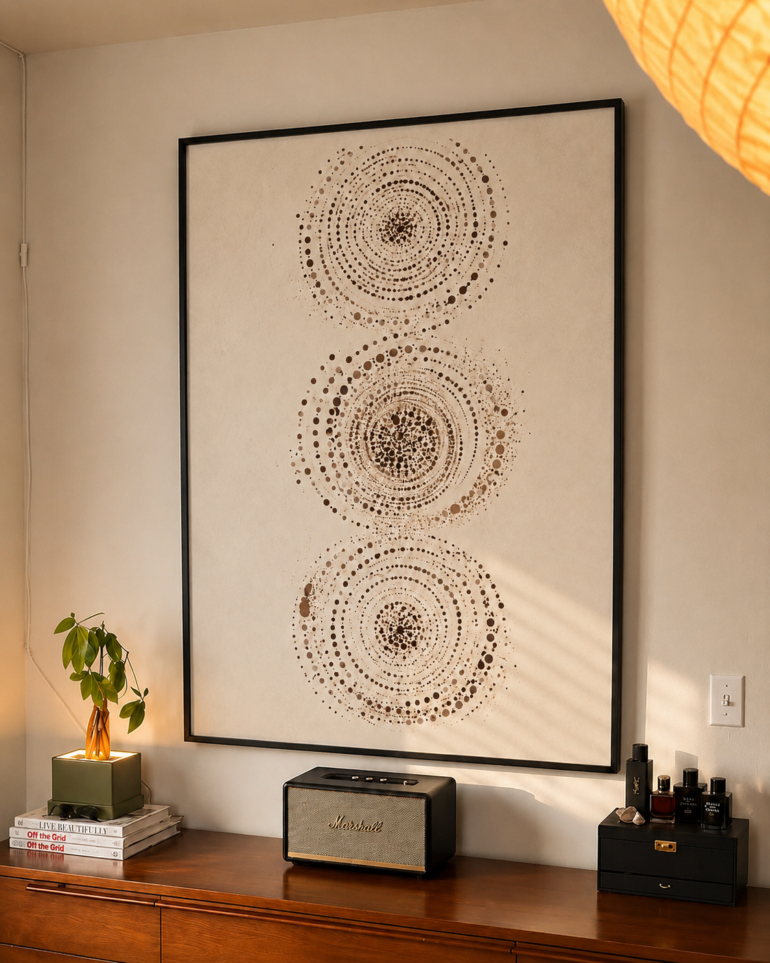 Abstract wall art print in black frame with three dotted concentric circle swirls