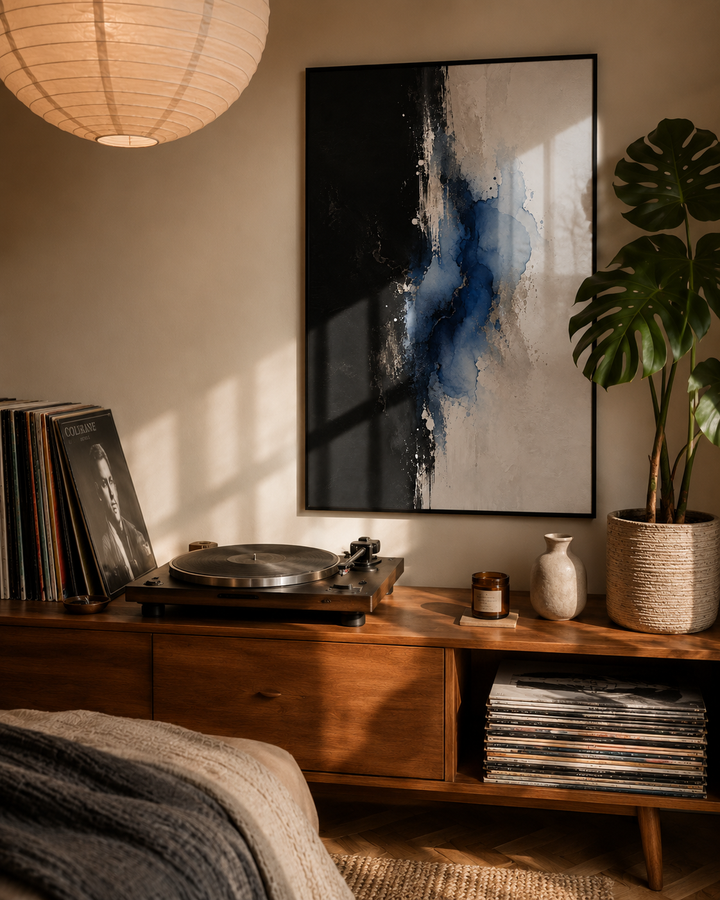 Abstract wall art print in black frame with blue watercolor strokes on a light background