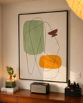 Black-framed geometric wall art with green, yellow, and dark line abstract shapes