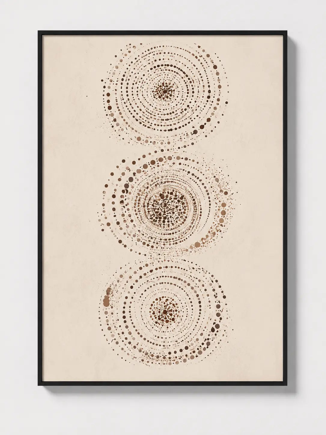 Abstract wall art in black frame featuring three dotted circular mandalas