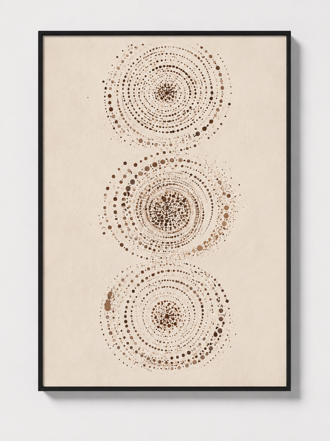 Abstract wall art in black frame featuring three dotted circular mandalas