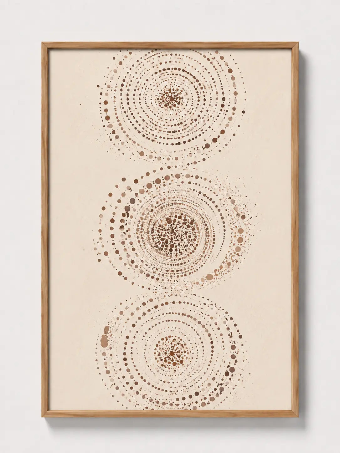 Abstract wall art print in light wood frame with three dotted concentric circles