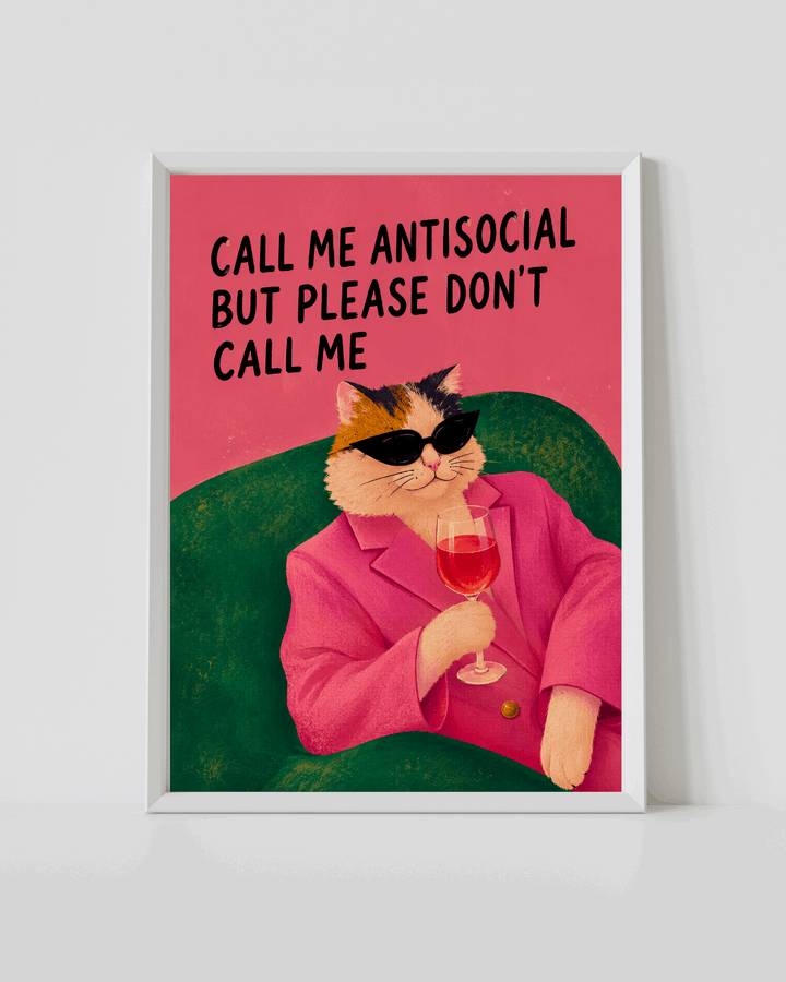 Framed cat poster with cat in pink suit holding a wine glass, red text