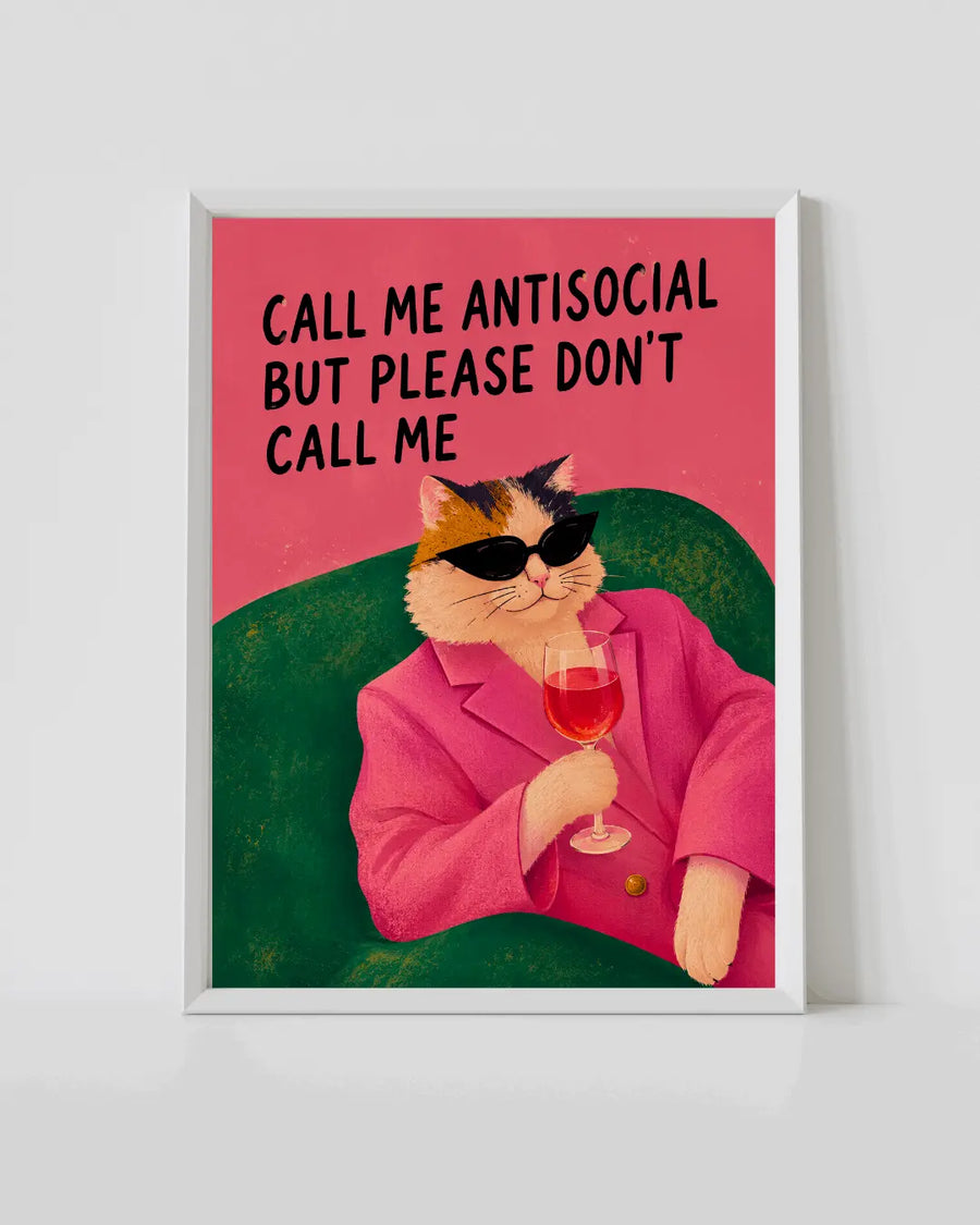 Framed cat poster with cat in pink suit holding a wine glass, red text