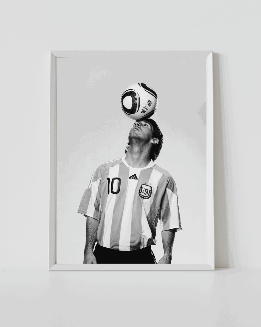 Framed white Argentina No.10 jersey poster with Messi and ball above head (black and white)