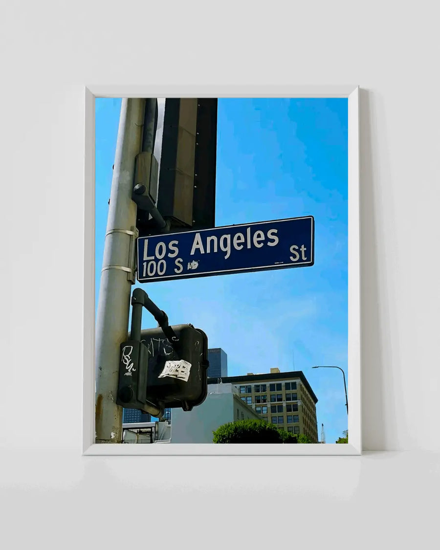 Street sign travel poster in white frame, blue sky and road sign