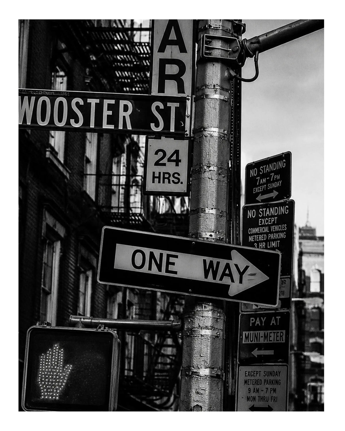 Street sign art print close-up with “One Way” sign and “Wooster St” street marker.