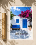 Courtyard print beside a poster tube, showing a blue door, white walls and pink bougainvillea