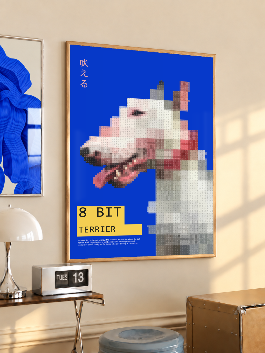 Pixelated white terrier head with yellow 8 Bit Terrier label on blue; oak framed print in a desk setting