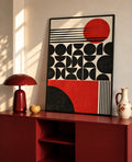 Framed red and black Bauhaus art print with geometric circles and stripes