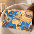 Framed vintage world map print on textured sofa, with blue oceans and ships