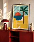 Bauhaus-style tropical art print in black frame, geometric palm and block shapes
