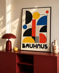 Black framed Bauhaus abstract art print with multicolor geometric shapes and BAUHAUS
