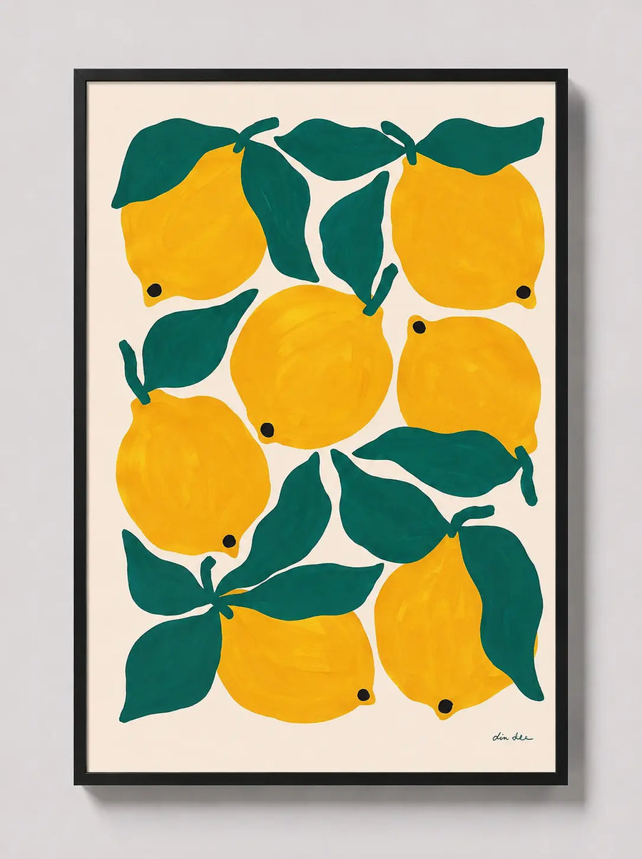Framed lemon and green leaf art print with yellow fruit, black frame