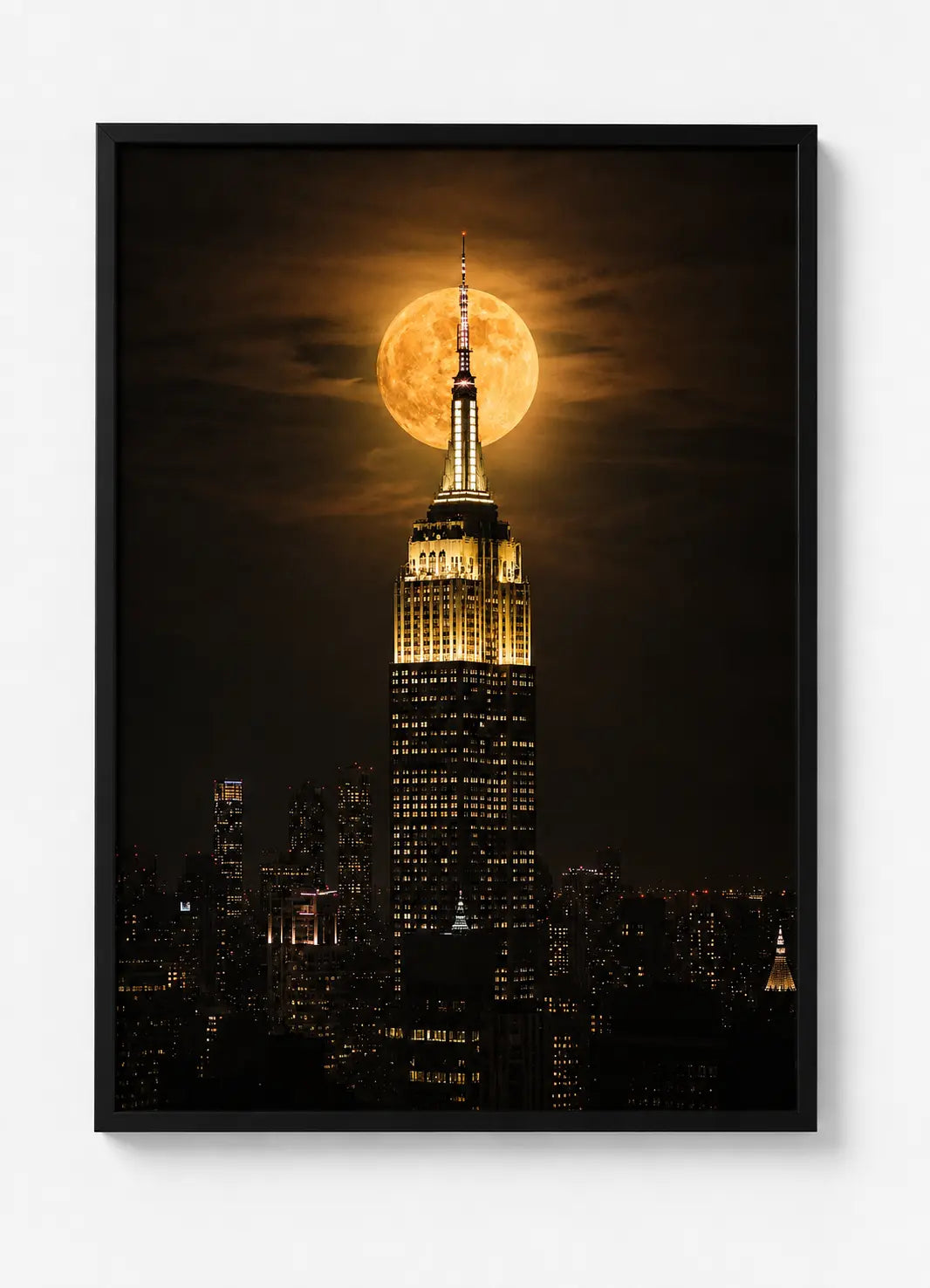 Black-framed wall art poster with Empire State Building under bright full moon