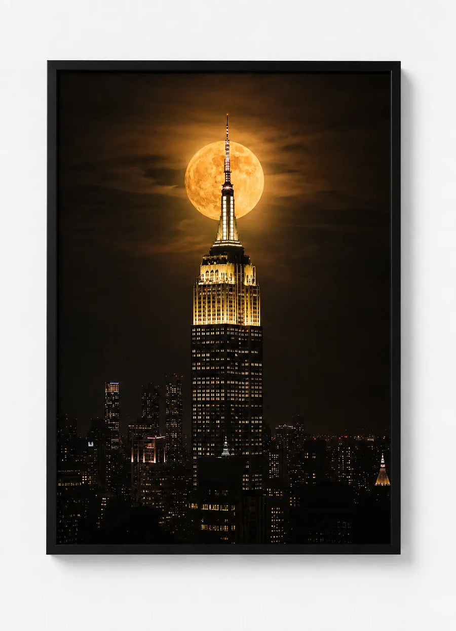 Black-framed wall art poster with Empire State Building under bright full moon