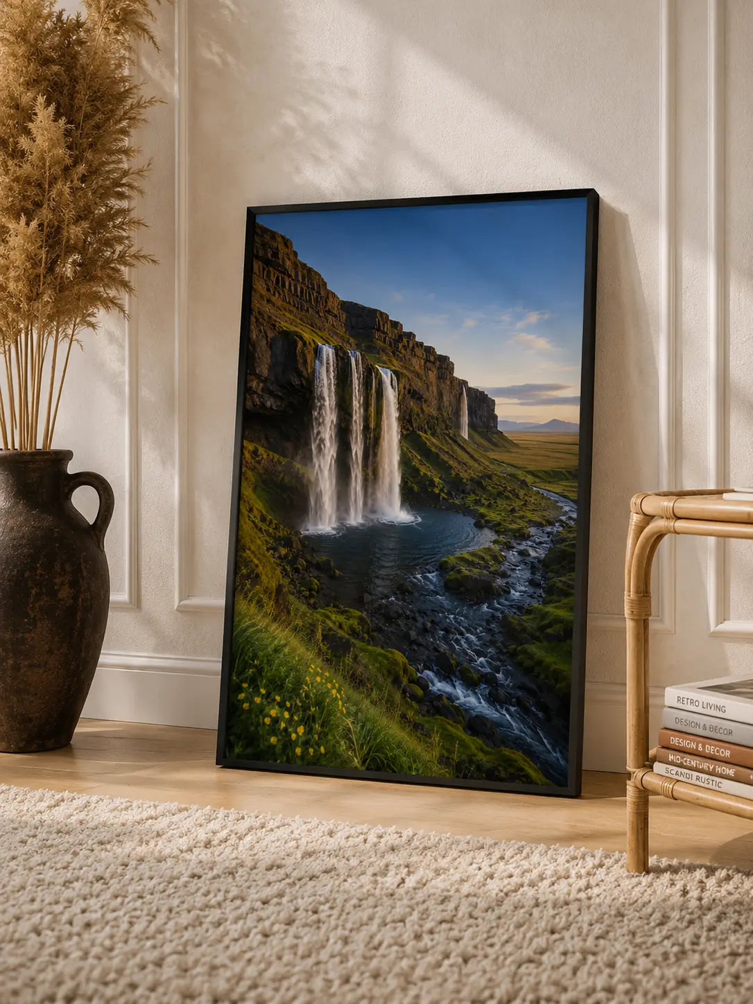 Framed mountain waterfall art print with river and cliffs, black frame.