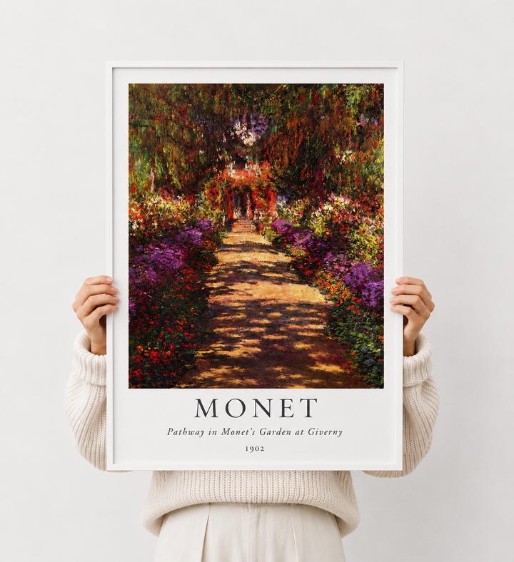 Framed garden pathway art print held by person, colorful trees and path