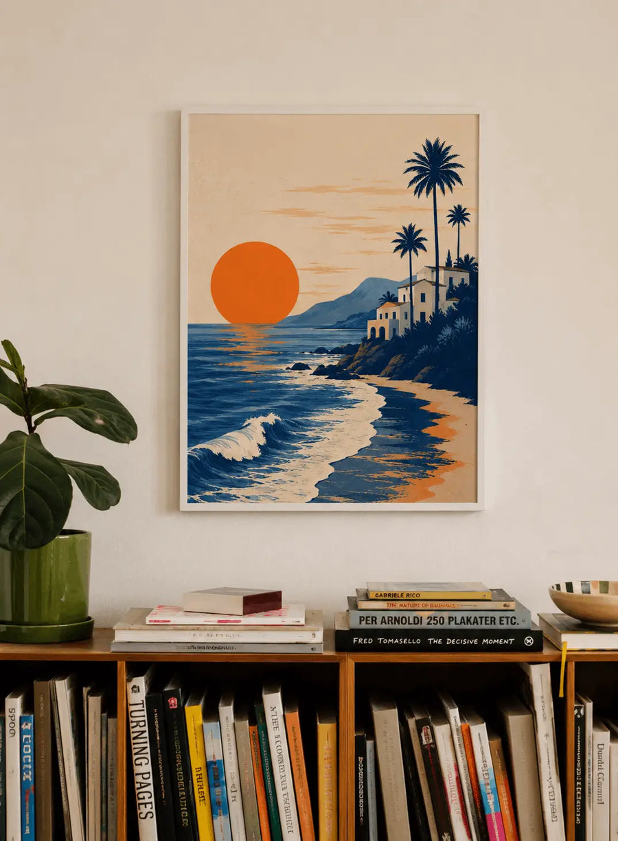 Framed beach poster with orange sun, waves, hillside houses, and tall palm trees