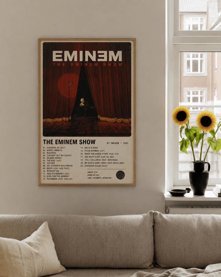 Framed rap music wall print with wood-tone border on living room wall, curtain artwork