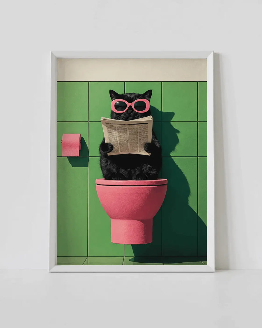 White-framed wall art poster: black cat with pink glasses reading book by pink toilet