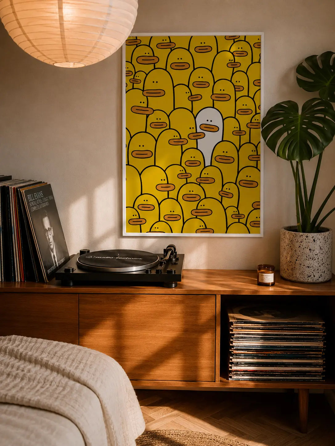 Framed yellow character-face graphic wall art with dark border.
