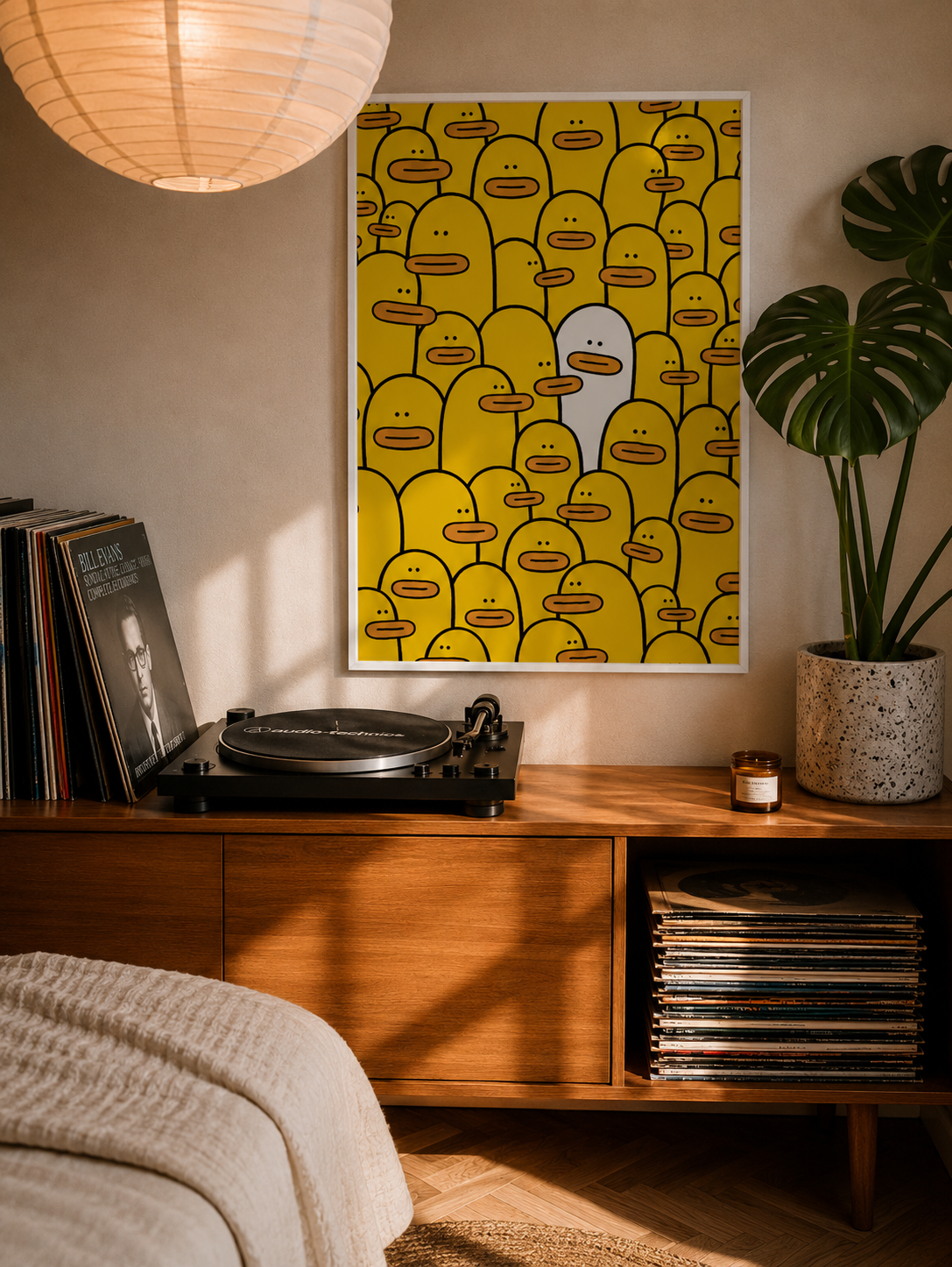 Framed yellow character-face graphic wall art with dark border.