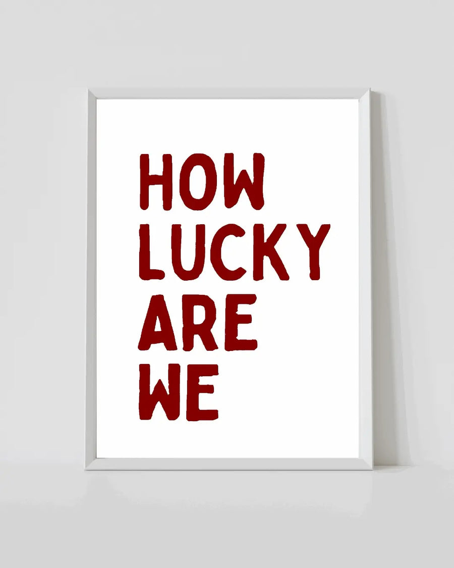 Framed quote print with white border and red 'How lucky are we' text