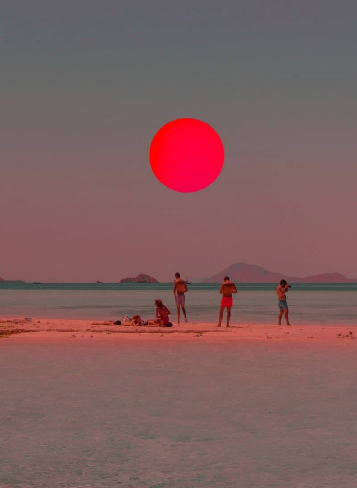 Close-up coastal print showing red sun circle over beach with people and mountains