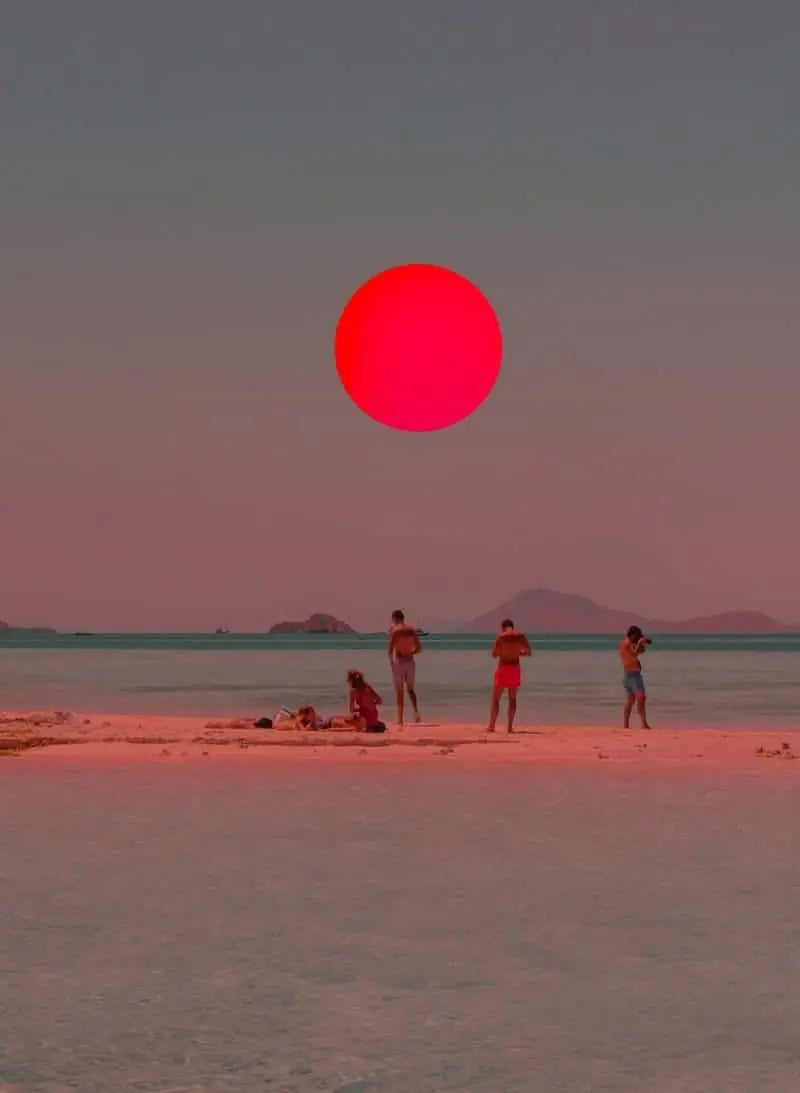 Close-up coastal print showing red sun circle over beach with people and mountains