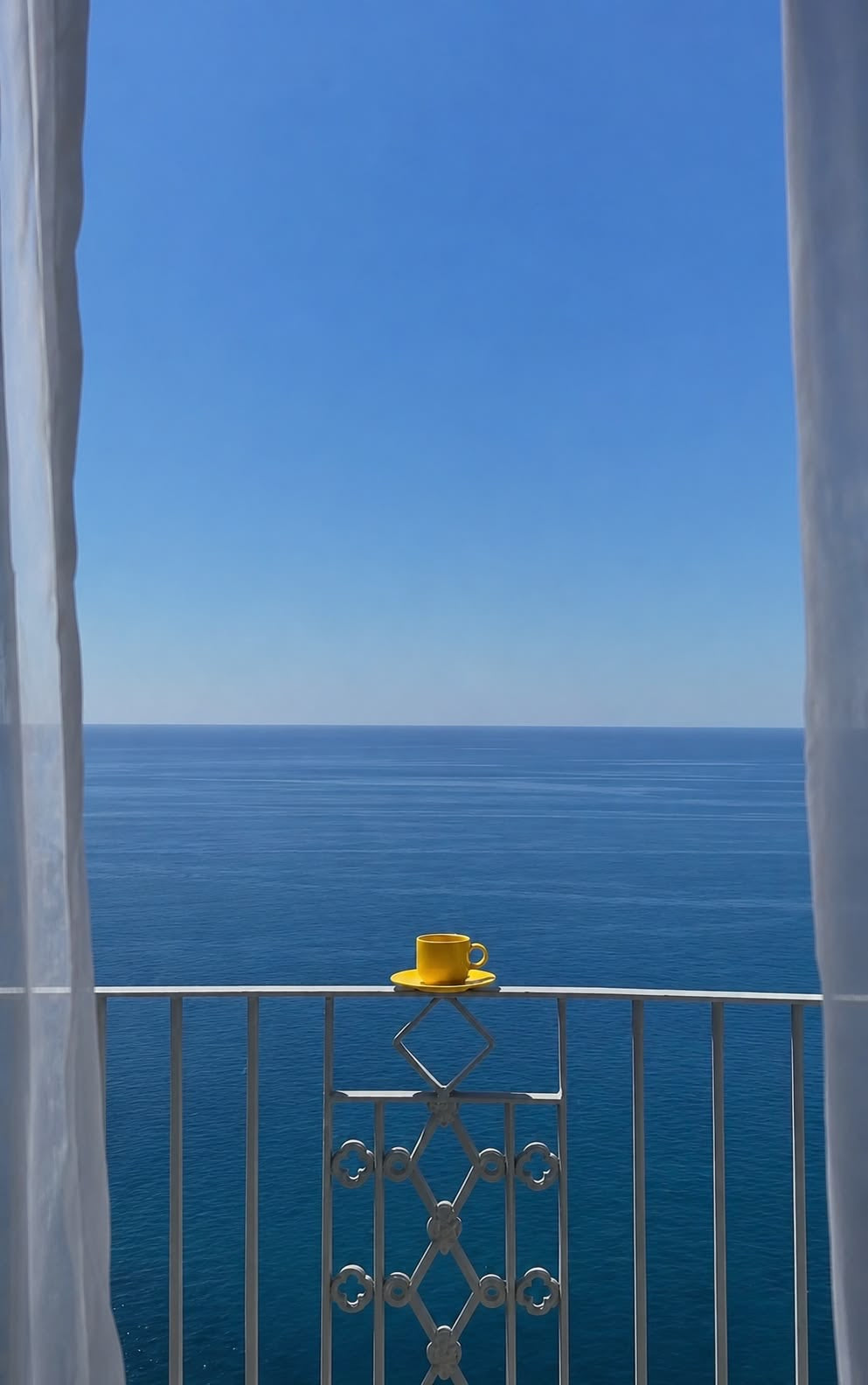 Sea View Balcony Print showing a minimalist coastal balcony with a single yellow cup facing the open sea.