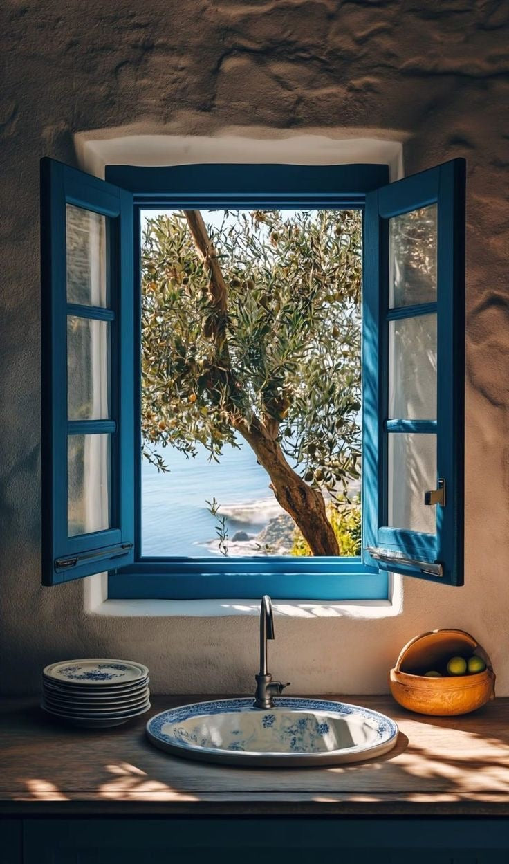 Olive Tree Window Print featuring blue shutters opening to coastal scenery with olive branches and natural daylight.