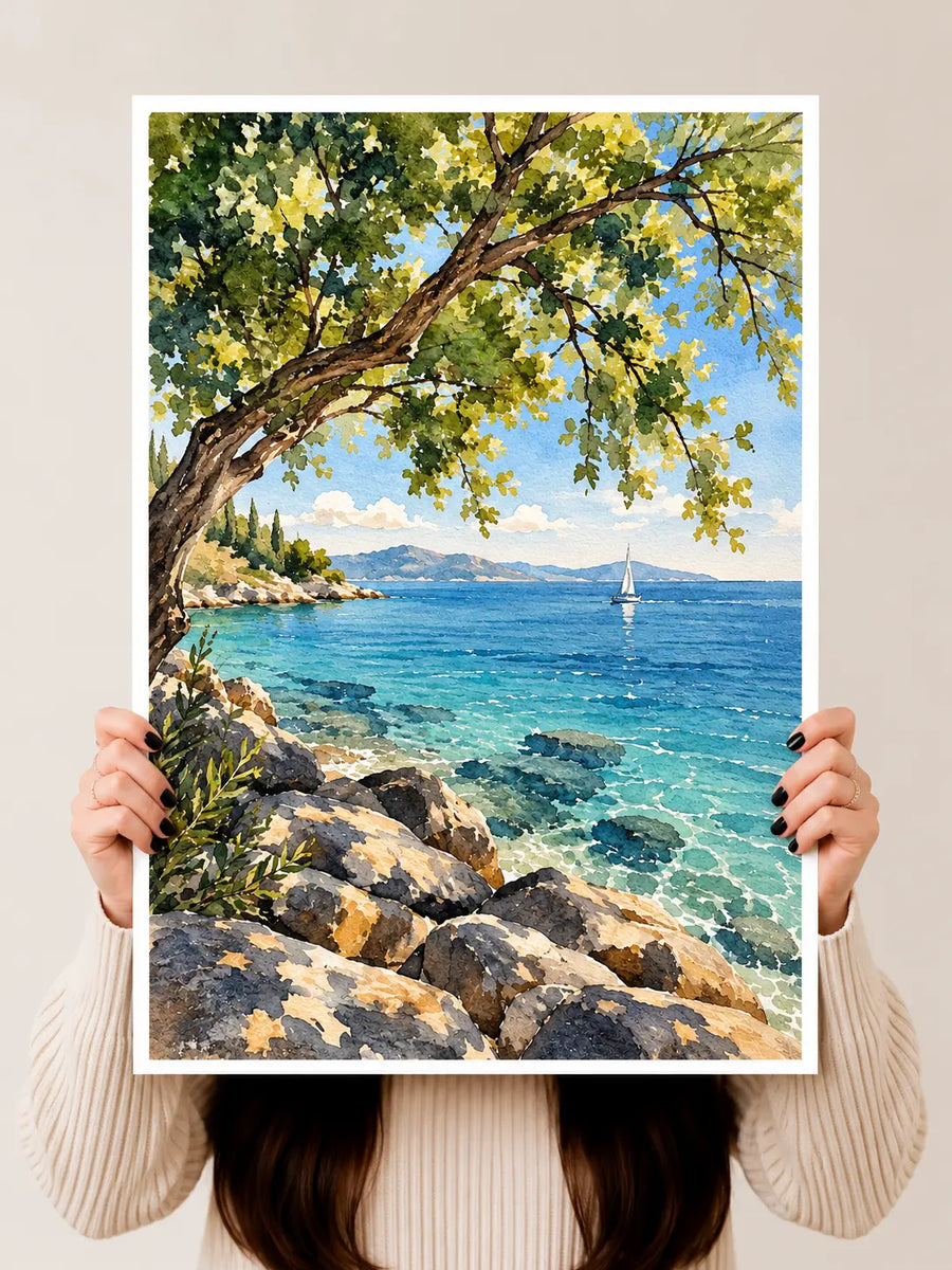 Mediterranean Coast Watercolor Art Print held upright to reveal rocky coastal textures, distant sailboats and layered blue washes