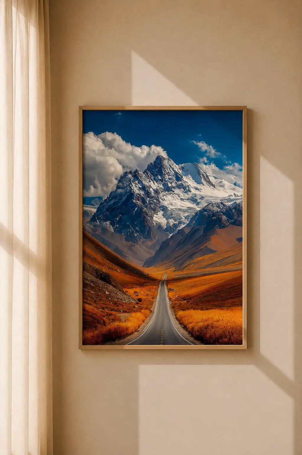 Framed mountain road art print with a winding road and snowcapped mountains, wood frame