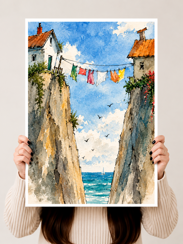 Mediterranean Street Watercolor Art Print held upright to showcase weathered stone walls, colorful laundry and distant coastal water