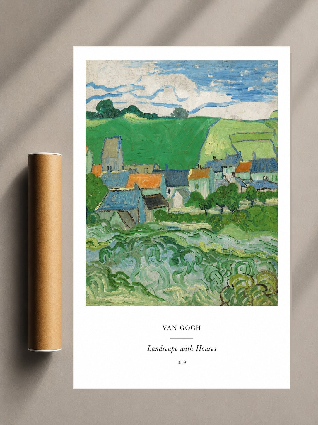 Framed landscape print of green hills, small houses, and winding fields