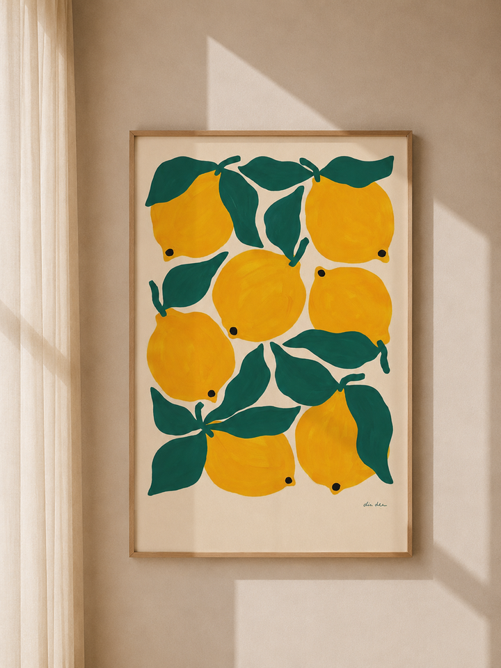 Lemon and green leaf art print with yellow fruit in a light wood frame