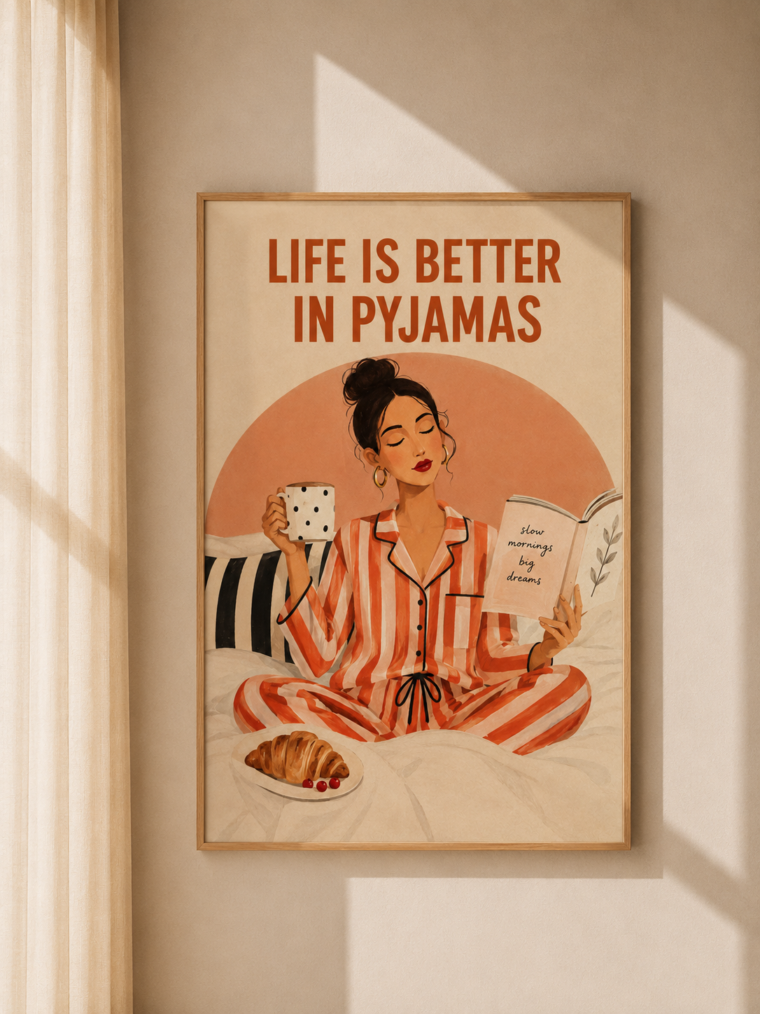 Wall art in wood frame: woman in striped pajamas with mug and book, “Life is Better in Pyjamas”