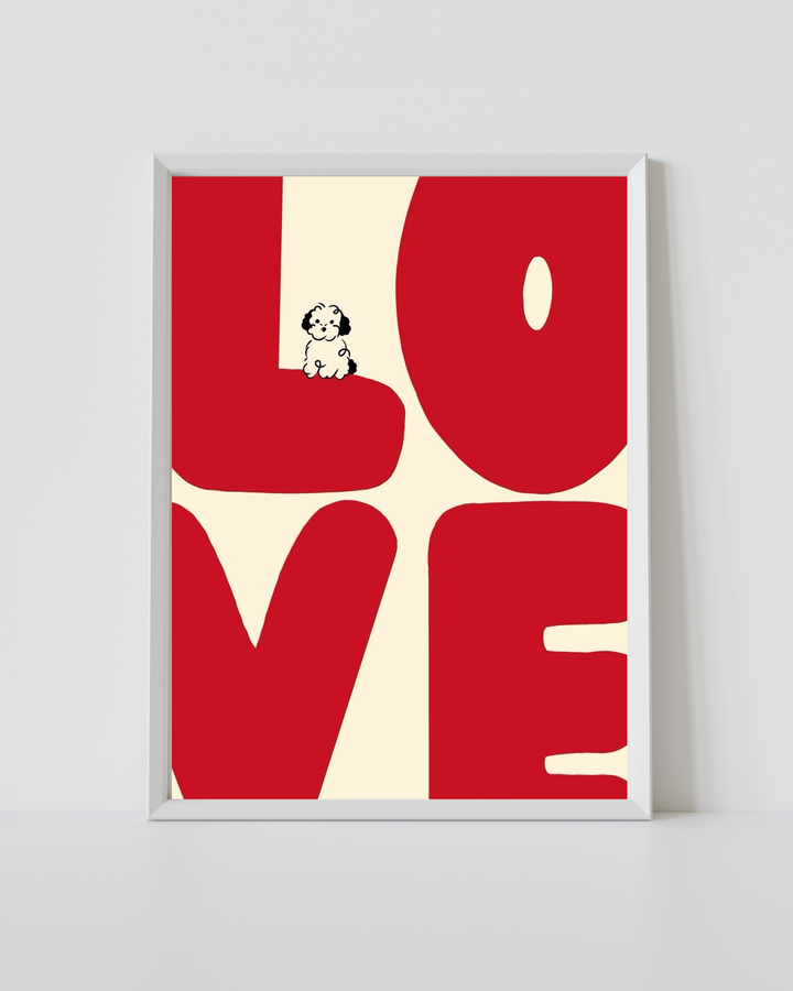 Love typography print in white frame with red letter shapes and small dog