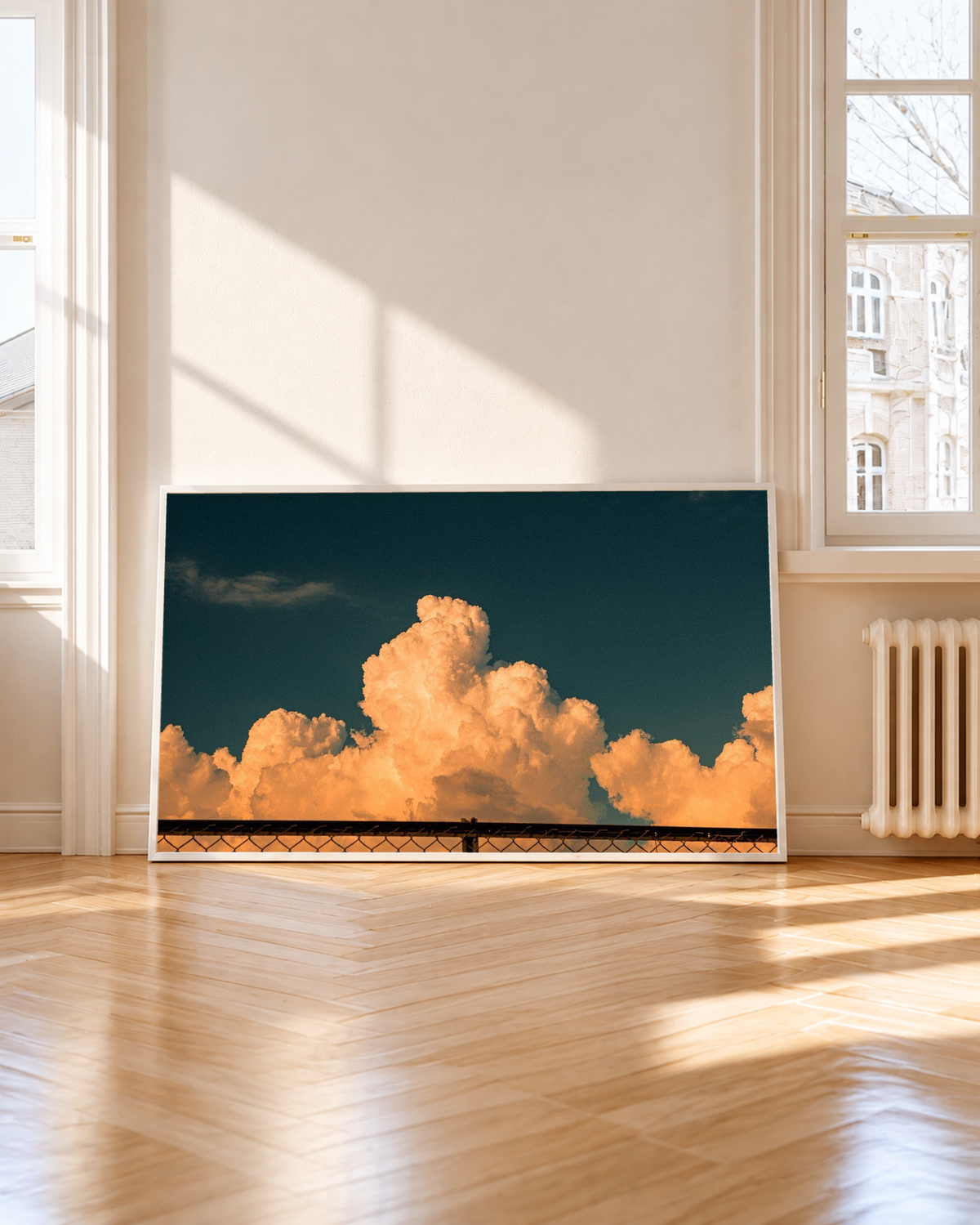 White  framed Orange Cloud Sky Wall Art presented against a clean white background, showing illuminated orange cloud clusters, subtle shadowed edges and a wide stretch of dark teal sky.