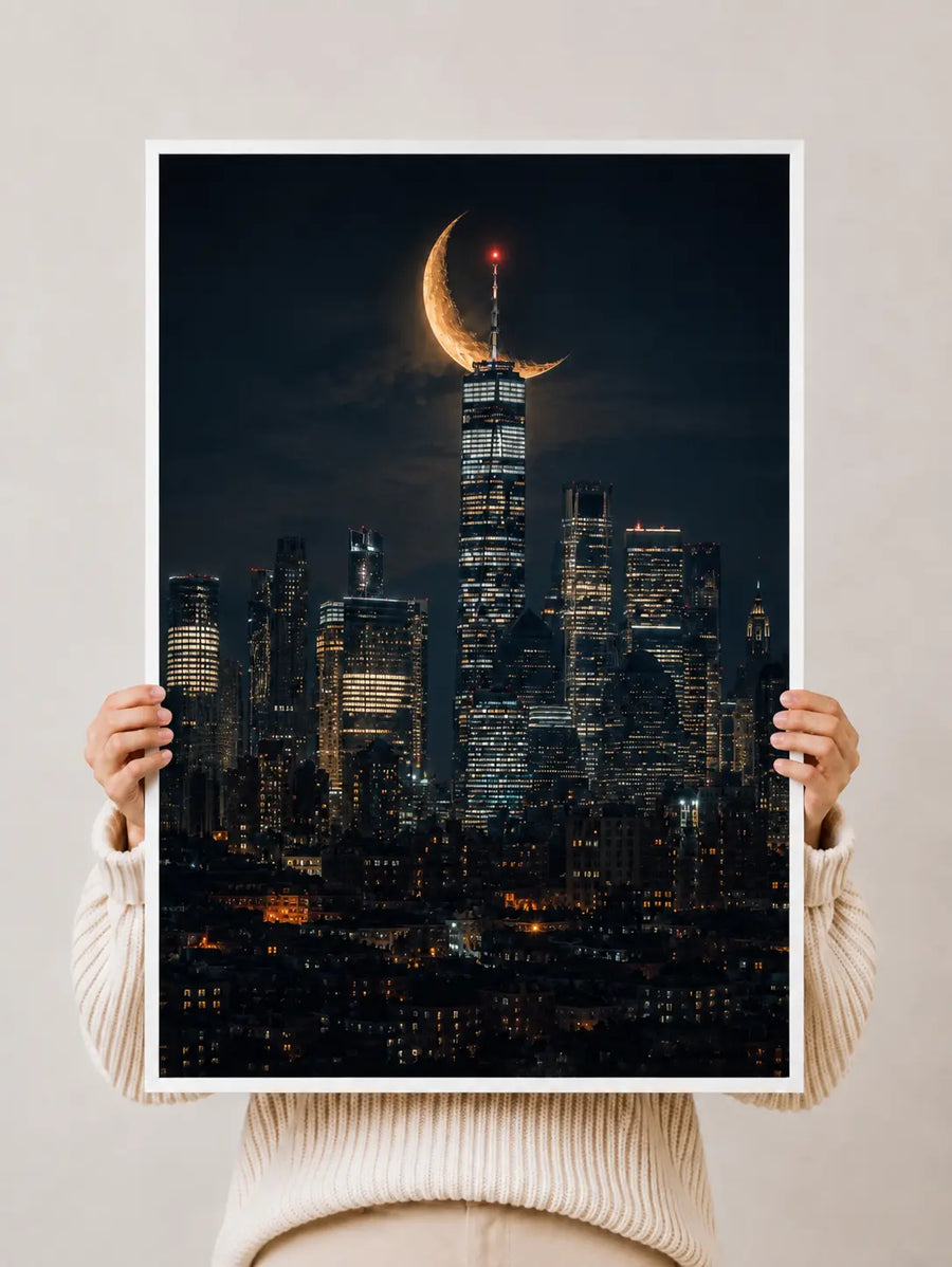 City skyline print with crescent moon, held up with hands and white border