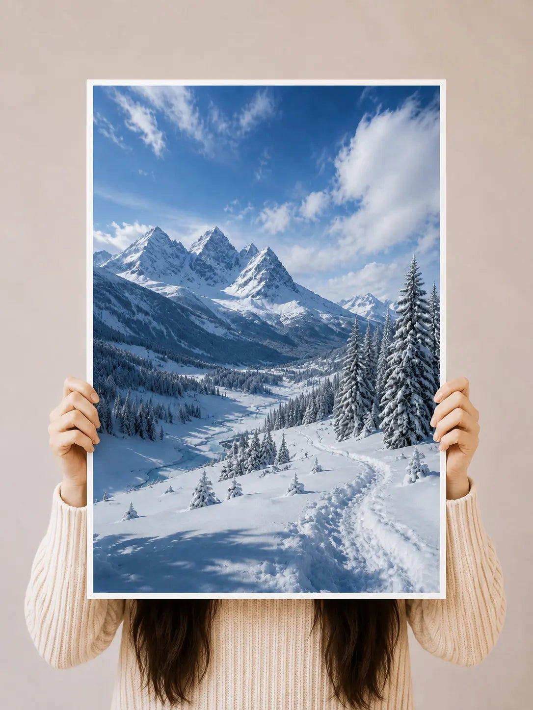 Unframed snowy alpine valley landscape art print held up, showing peaks, fir trees, and trail