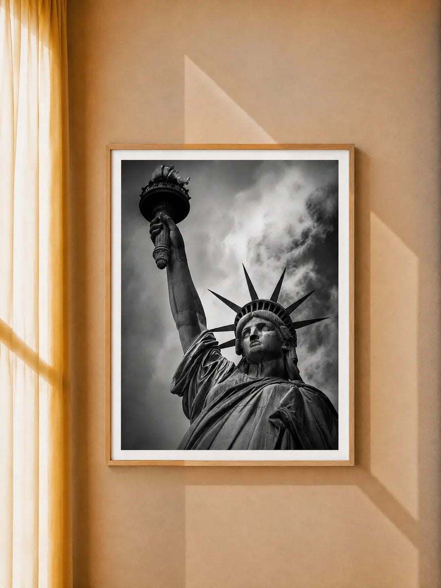 Statue of Liberty Art Print displayed in a black frame within a warm contemporary living space