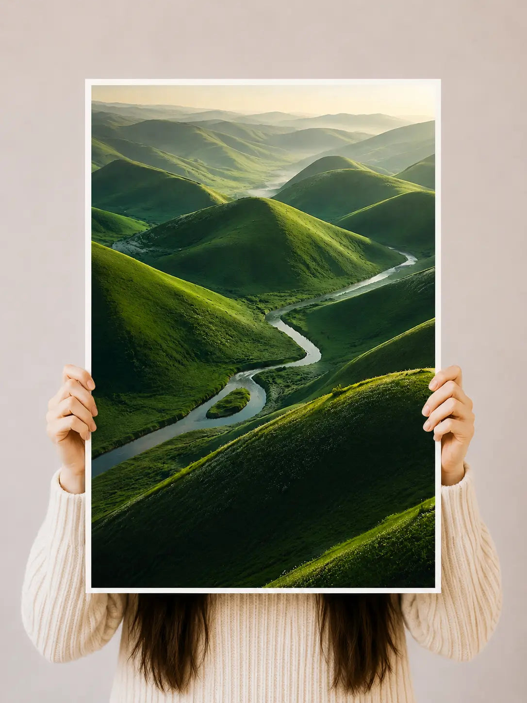 Green hills winding road landscape poster held upright by a person