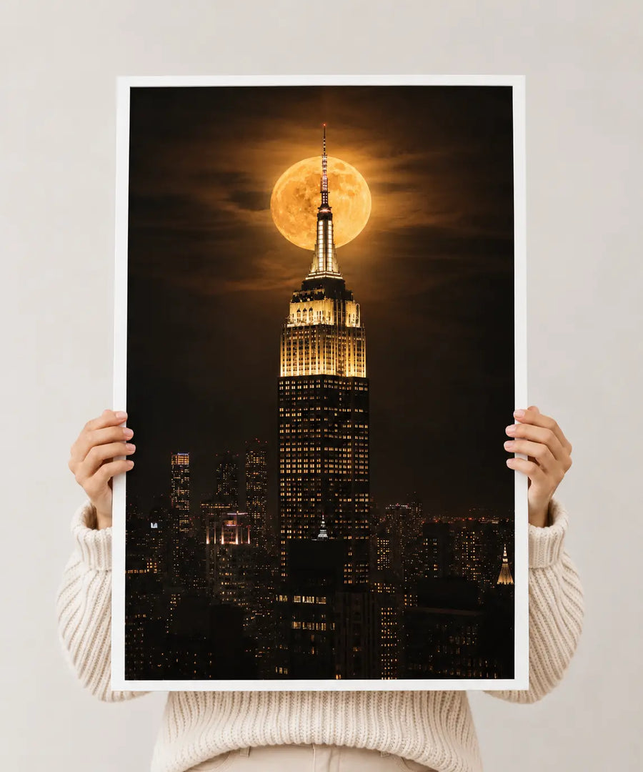 White-bordered print of Empire State Building with full moon in the sky