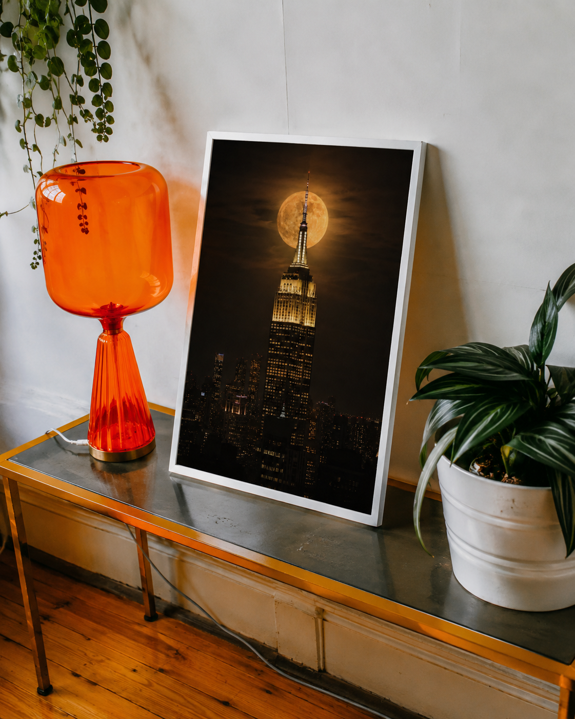 NYC skyline wall art showcasing the Empire State Building aligned with a bright full moon above the city lights.