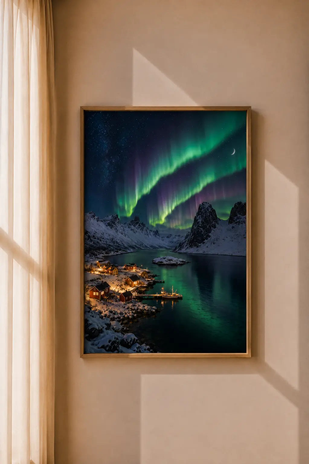 Framed Northern Lights aurora art print on wall, snowy mountain village beneath green lights