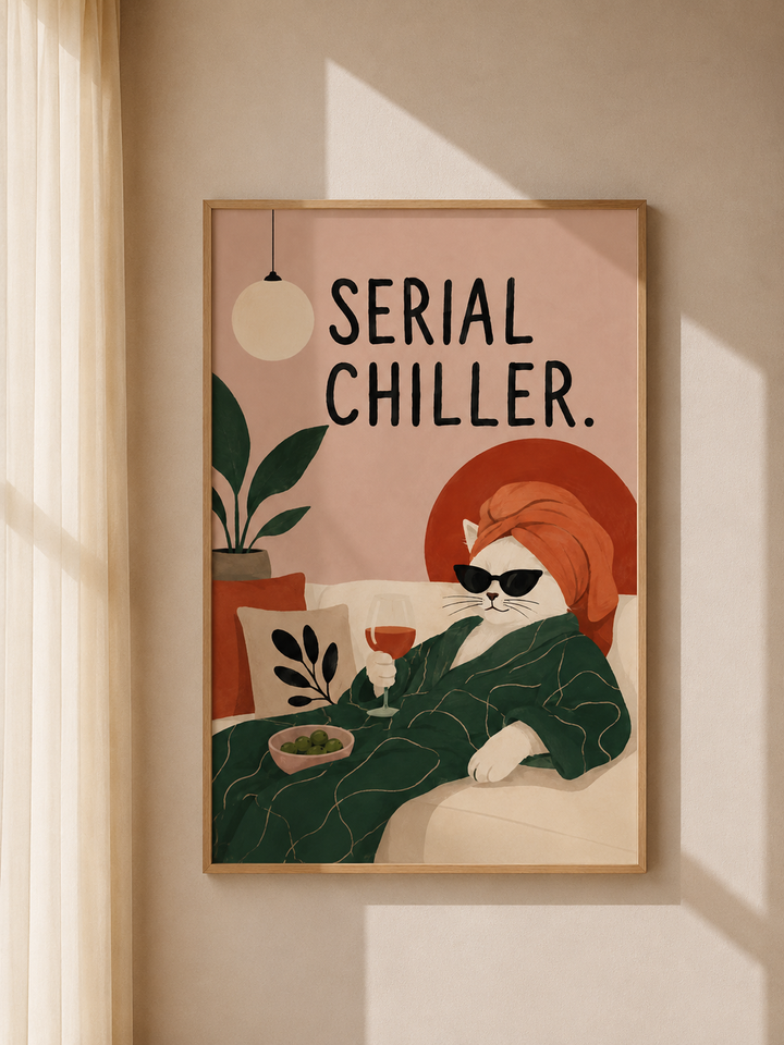 Wood-framed cat art print with orange cat in glasses, green plants, and “Serial Chiller”