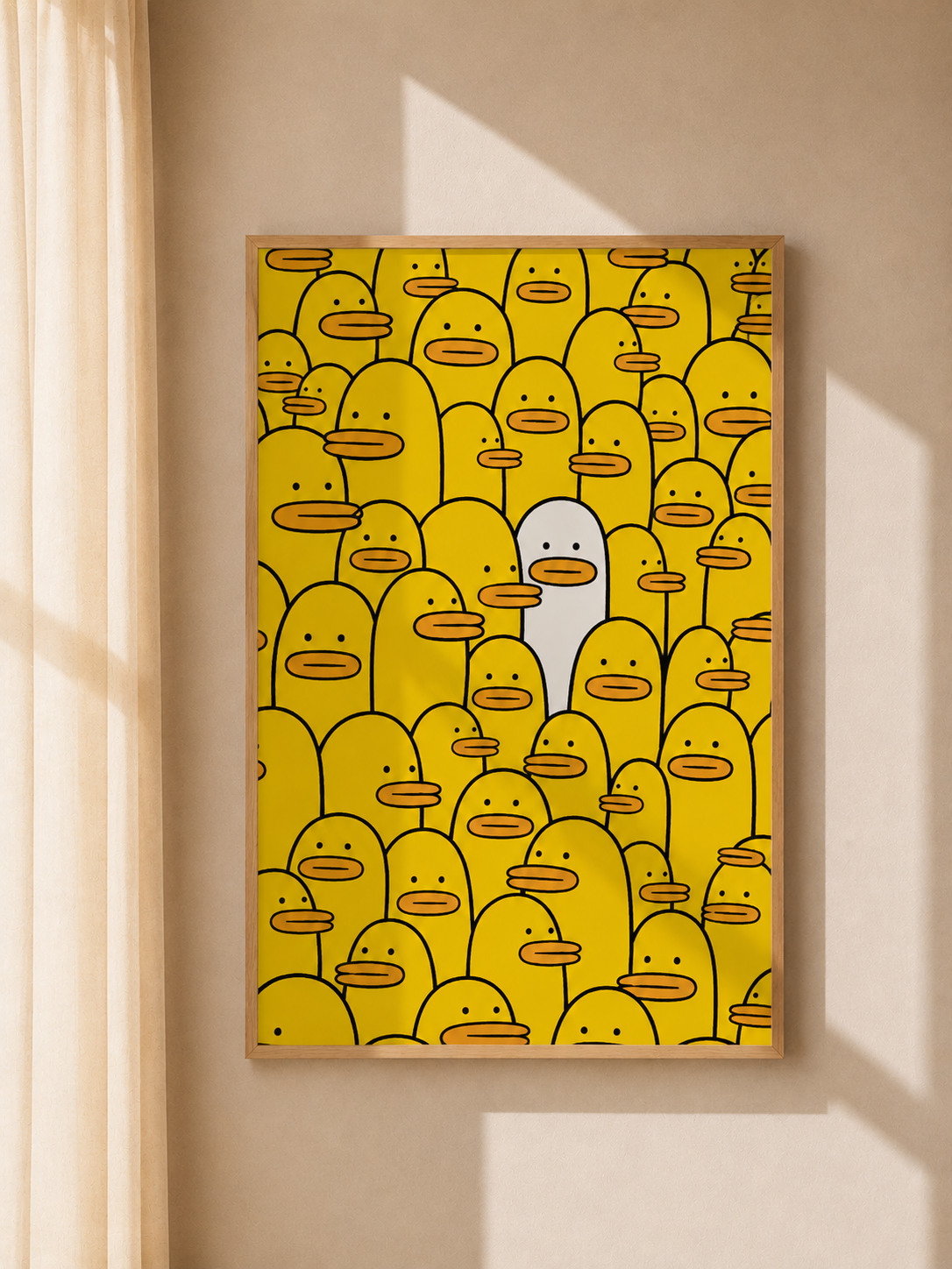 Framed yellow character-face graphic wall art on a wall.