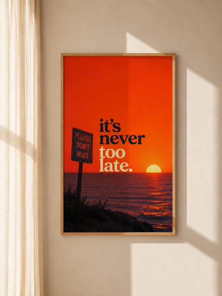 Brown-framed motivational wall art with “it’s never too late” and orange sunset glow.